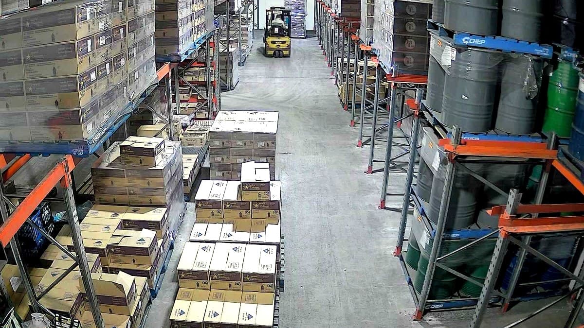 Wide aisle inside the cold-storage freezer with palletised stock and racking at the Rocklea facility